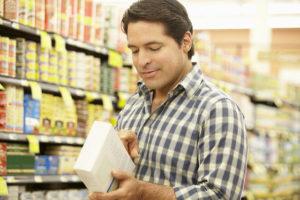 man reading food label 