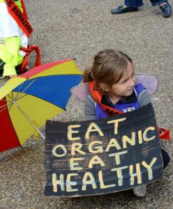child with eat organic sign